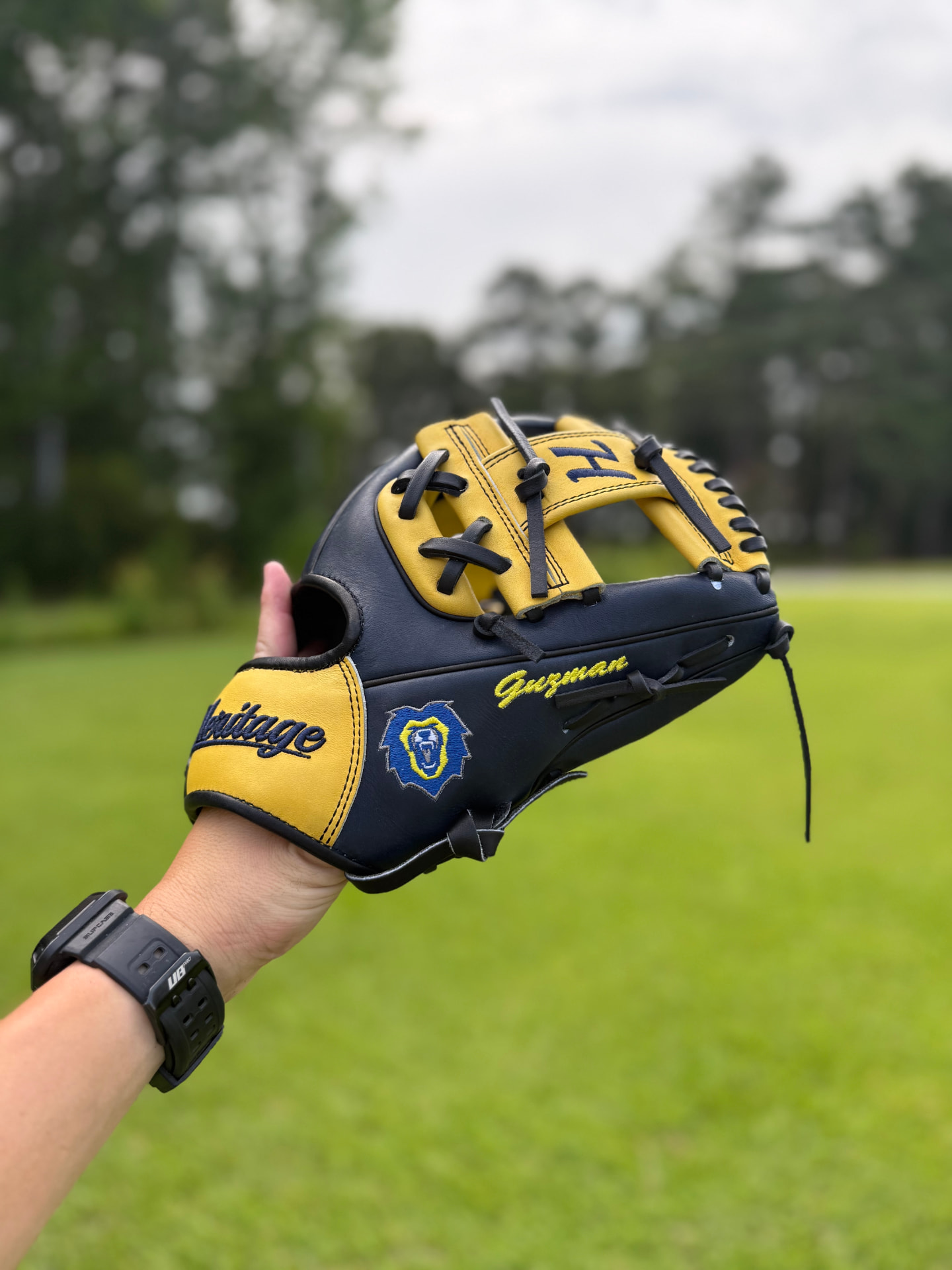 Black and gold Heritage glove personalized 'Guzman' with team badge